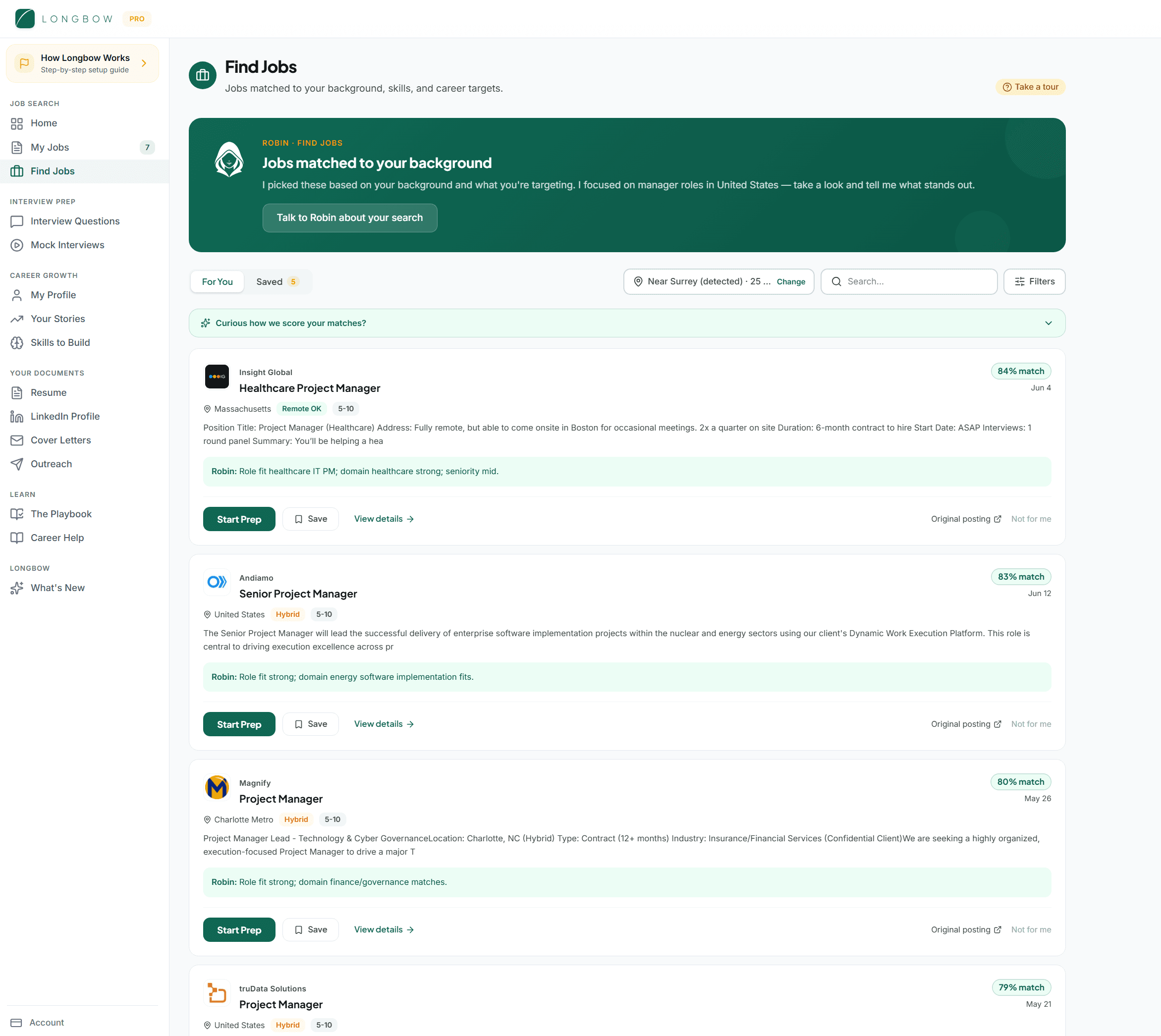 The Find Jobs feed in Longbow. A location chip reads 'Near Surrey (detected)'. Four job cards show match scores of 84, 83, 80 and 79, each with a one-line reason from Robin underneath, and a link asking 'Curious how we score your matches?'